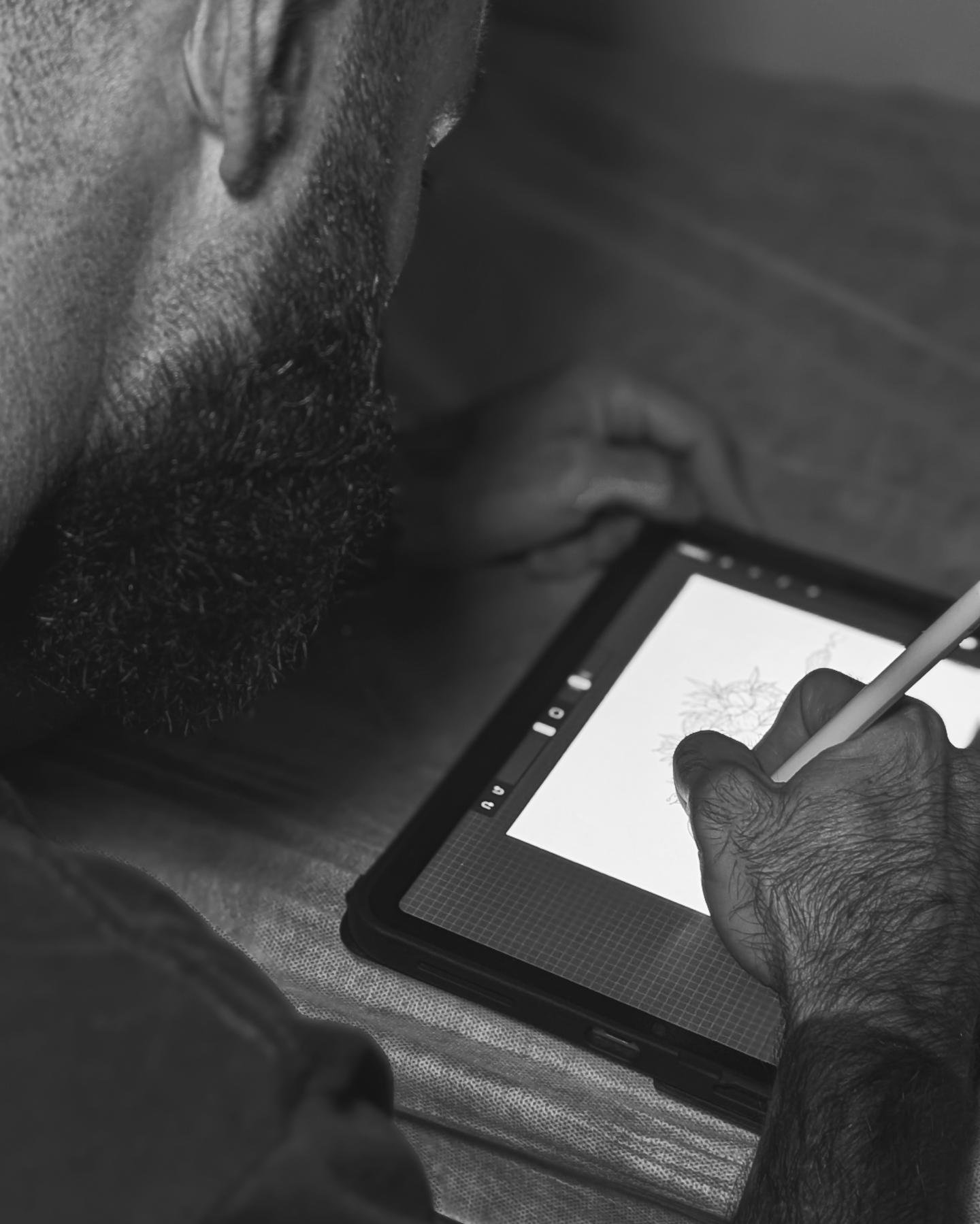 Nick Tyler sketching a custom tattoo design